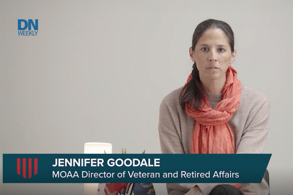 Person seated indoors wearing a scarf, with on-screen text identifying Jennifer Goodale, MOAA Director of Veteran and Retired Affairs.